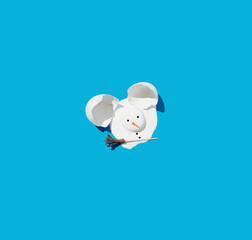 Creative winter or Christmas composition with melted Snowman from a white egg on a sunny day. Minimal concept of New Year or Christmas on a vivid blue background. An elegant winter banner idea