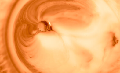 An abstract art background resulting from the addition of swirls of different coloured acrylic paints to a milk and paint base.