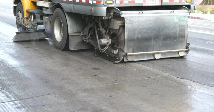 Close up of a street sweeper cleaning a big road