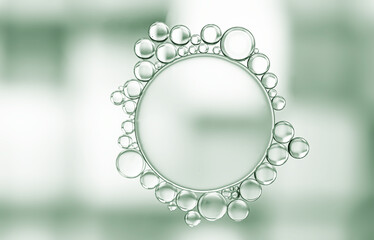 Obraz premium Abstract pattern created by a mass of oil droplets of different sizes on a water base with champagne blue-green highlights background.