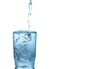 Water pouring over  glass isolated on white background.	