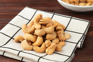 Cashew nuts in tablecloth on wooden table, Healthy snack, Vegetarian food.