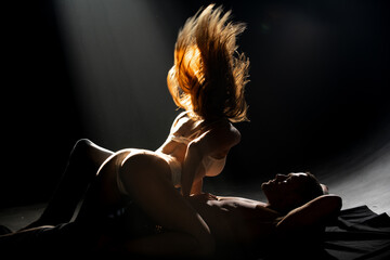 Romantic portrait of a sensual couple in love. Passionate man kissing sensual woman. Embrace and...