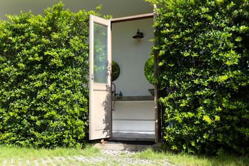 The two wooden doors were opened, with trees on the sides that were planted together to form a wall.