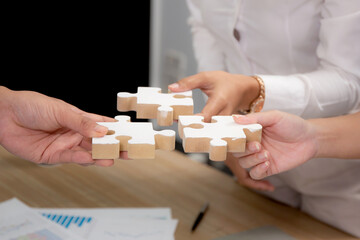 Hands of team young business and partner holding piece jigsaw for assembly is metaphor, teamwork...