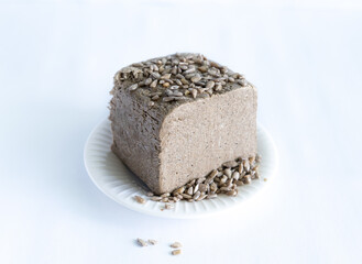 halva from sunflower seeds on a white plate. national traditional sweetness of turkish halva on the table. High quality photo