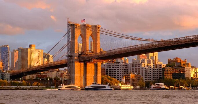 Brooklyn Bridge on sunset with multiple transportation ships