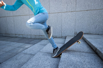 Skateboarder riding  skateboard goring down the stairs outdoors in city