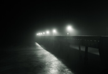 Light along pier at night