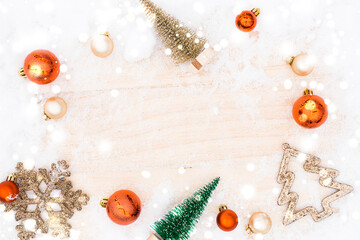 Fototapeta na wymiar Table wood Christmas. Xmas board with old rustic wall, white frozen snow, golden balls and gift box. Winter wooden decoration background. Happy new year copy space.