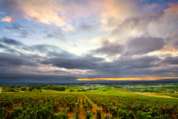 Clouds at sunrise time over vineyards of Beaujolais, France
