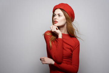 pretty woman in a red sweater cosmetics emotion studio posing