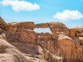 Um Frouth Rock Bridge, a high natural rock bridge in Wadi Rum desert, Jordan.