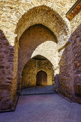 Medieval stone wall and arched entrance door. Buitrago de Lozoya Madrid.