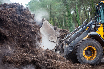 bulldozer handling compost for spreading or garden - 469046789