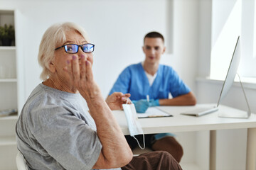 Fototapeta premium an elderly woman is examined by a doctor professional consultation