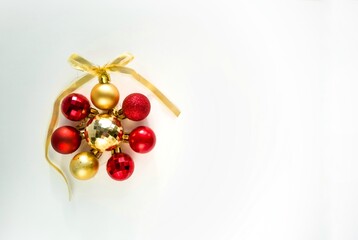 Christmas balls in round. Gold and red christmas ball with ribbon bow on white background. New Year background. Christmas balls close up picture.