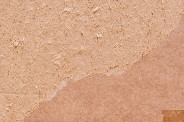 Brown cardboard sheet abstract background, cardboard box texture and background. Detail of peeling brown paper box material old vintage pattern for design art work
