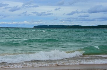 a stunning view across the turquoise-colored water of lake michigan  from the beach at sleeping  bear point in sleeping bear dunes national lakeshore in the lower peninsula of michigan