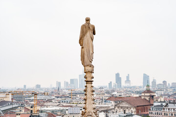Fototapeta na wymiar Statue on the spire of the Duomo. Milan, Italy