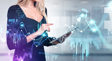 Businesswoman finger point at tablet, graphs and lines hologram, office room