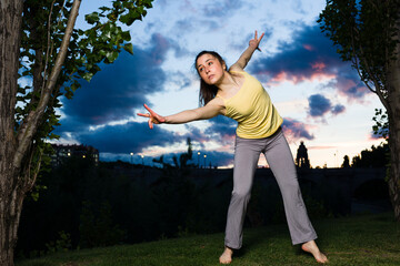 Fototapeta na wymiar ballet ballerina dancer motion in happy joyful Rhythm . Hispanic woman healthy life outdoors 