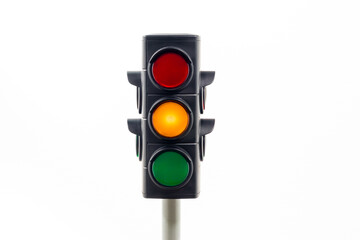 Isolated traffic light showing an illuminated amber light.  Concept image illustrating control of...