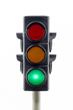 Close-up view of a traffic light showing an illuminated green light.  Concept image illustrating freedom and control of the COVID pandemic.

