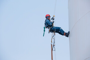 Male worker rope access  inspection of thickness