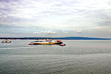 Obraz premium Vessels, passenger ships and tugboats in port under cargo operations and underway. Port of Surabaya, Indonesia, January,2021