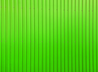 Building wall clad in green plastic siding