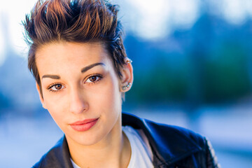 headshot froma a yooung hispanic female. Beautiful woman with an ambiguous hairsyling