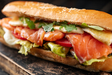 Closeup on appetizing salmon sandwich with herbs