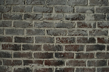 Old brick wall. Brickwork from an red old brick in a rustic style. The structure and pattern of the stone wall. Copy space.