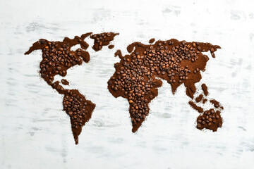 World map. Fragrant coffee beans on a white wooden background. Traditional drinks. Top view.