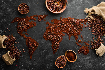 Set of coffee beans and ground coffee in the shape of a world map. Top view. On a dark background.
