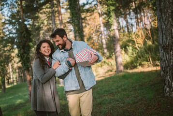 Fototapeta premium Happy young couple in love, with christmas gifts. Festive holiday decorations.