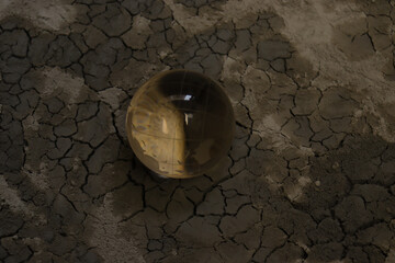 A dry surface of land with earth globe