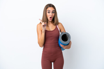 Young sport caucasian woman going to yoga classes isolated on white background intending to realizes the solution while lifting a finger up