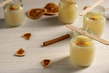 Set for crafting candle on wooden background. Eco soy wax on white table. DIY candle. Hobby concept.