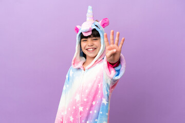 Obraz na płótnie Canvas Little kid wearing a unicorn pajama isolated on purple background happy and counting four with fingers