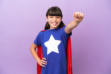 Little kid isolated on purple background in superhero costume with proud gesture © luismolinero