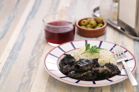 chipirones en su tinta, small squid cooked in black ink, spanish basque cuisine