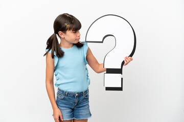 Little caucasian kid isolated on white background holding a question mark icon and with sad expression