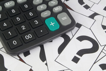 Calculator on question marks background.