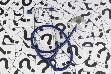 Health care and medical questions concept. Stethoscope on question marks.