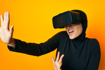 cheerful woman in black hijab VR glasses emotions studio lifestyle