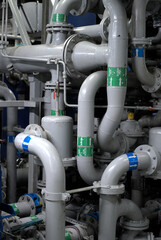 Industrial Piping and valves. Modern Ship interior - Pipe and valve system located inside engine room of a modern ship