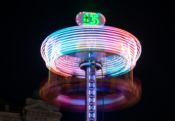 Colorful rotating carousel in the city at night