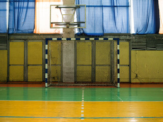 Futsal goal and basketball hoop in the school gym.